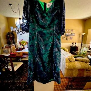 Navy and green lace covered cocktail length dress by JS Collections.